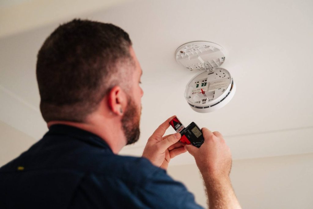 DC Smoke technician servicing smoke alarms