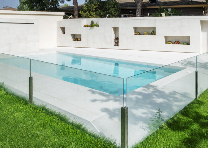 Certified pool safety inspector checking a pool fence