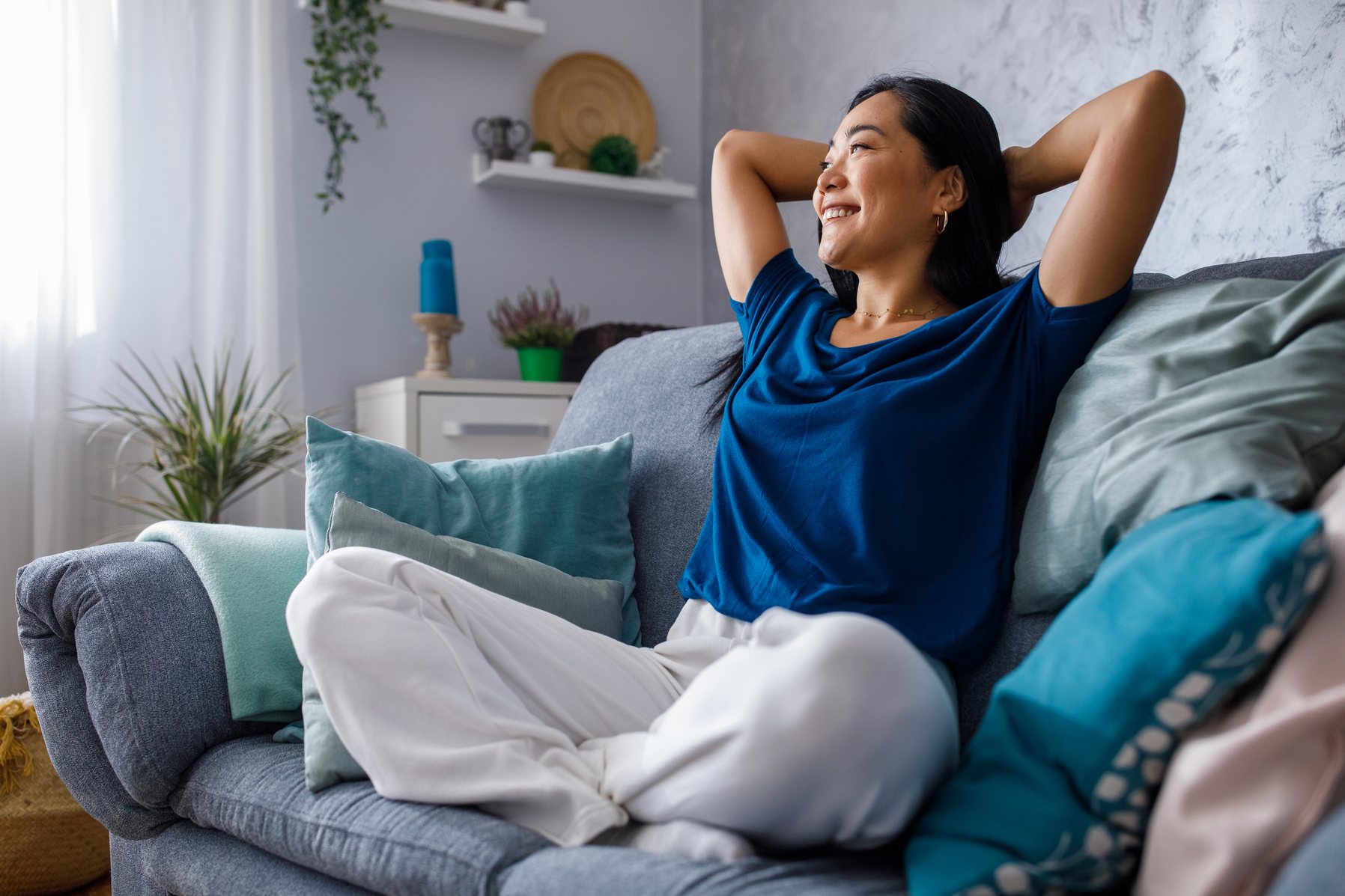 Woman relaxing on a lounge in her Queensland home